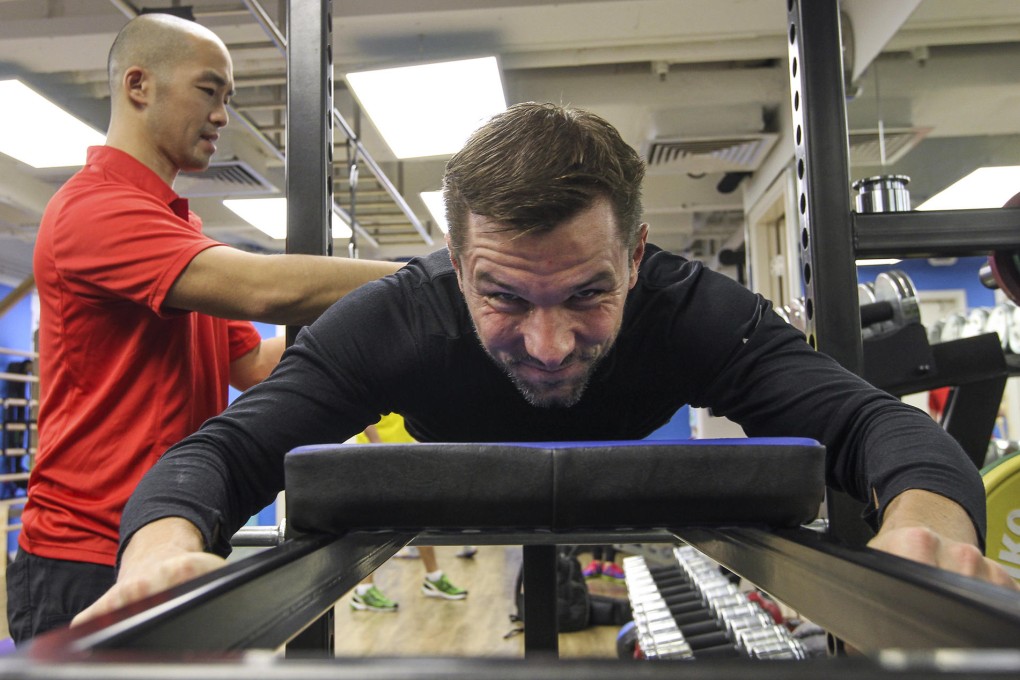 Mikey Leung works with a client as part of the Poliquin method (left and below).Photos: Edward So
