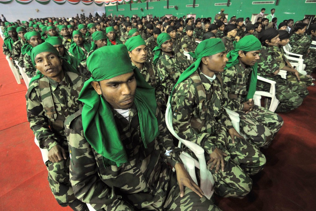 Assam separatist militants lay down their weapons in 2012. Photo: AFP
