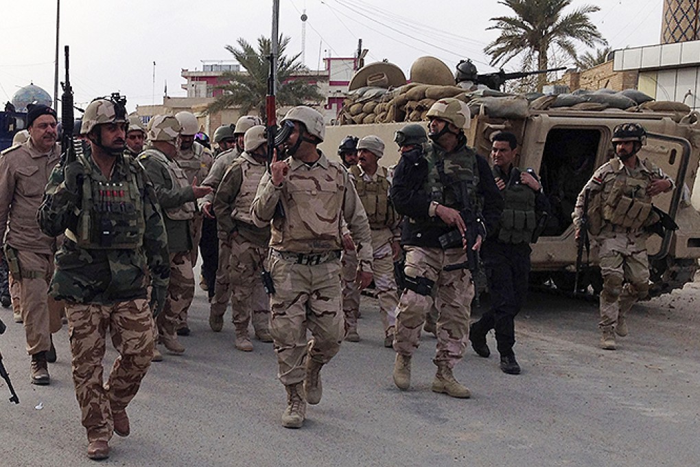 Iraqi soldiers take positions during an intensive security deployment in the province of Anbar. Photo: Reuters