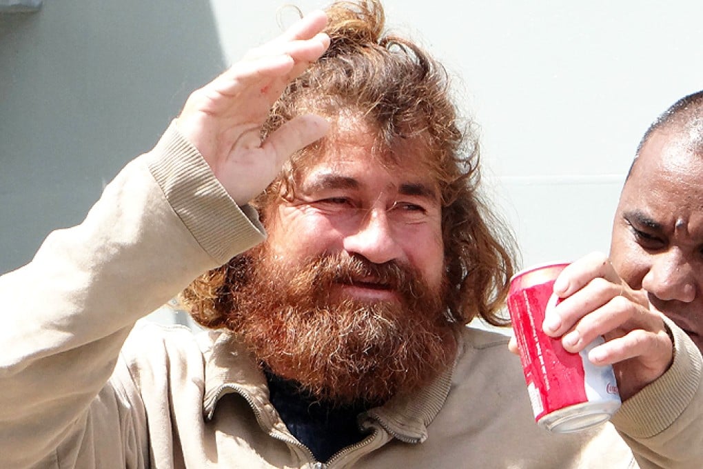 Mexican castaway Jose Salvador Albarengo walks with the help of a hospital nurse in Majuro after a 22-hour boat ride from isolated Ebon Atoll on Monday. Photo: AFP
