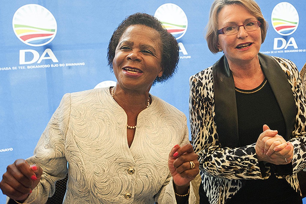 Mamphela Ramphele dances as she stands next to Helen Zille (right), leader of the Democratic Alliance party. Photo: AFP