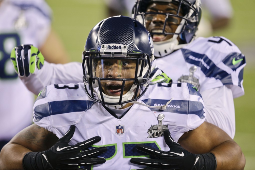 Seahawks linebacker Malcolm Smith celebrates after running back an interception for a touchdown against the Denver Broncos. Photo: AP