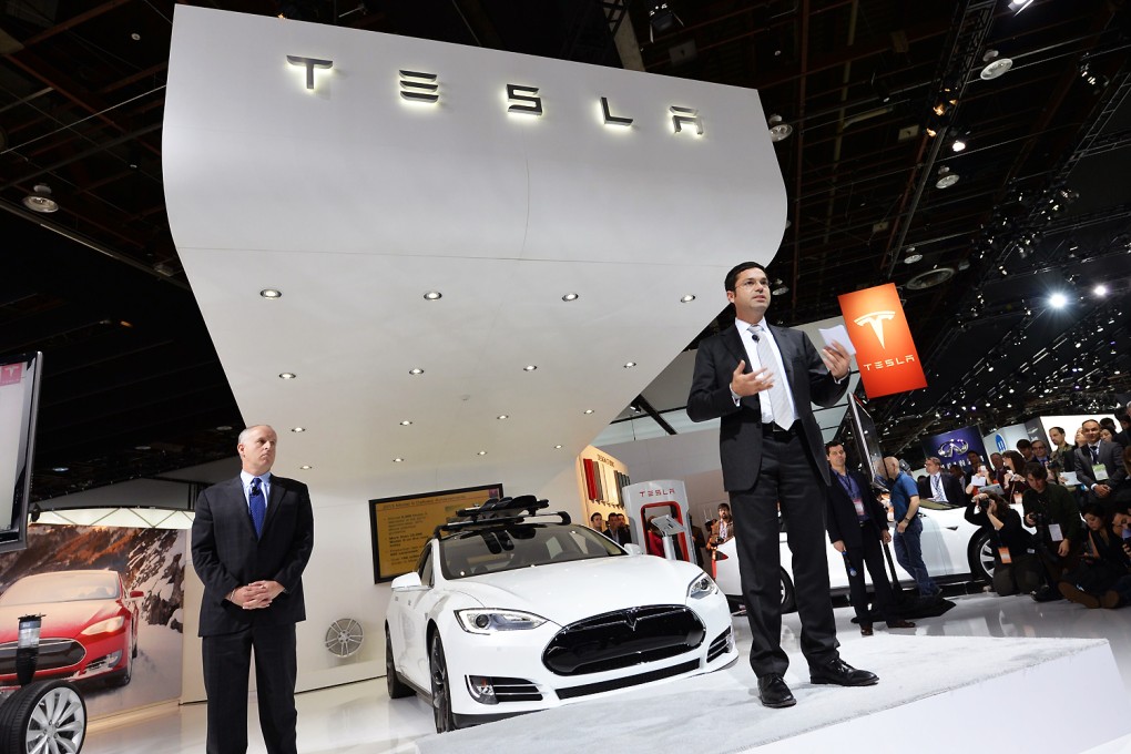 A Tesla car is unveiled in a Detroit showroom. Photo: AFP