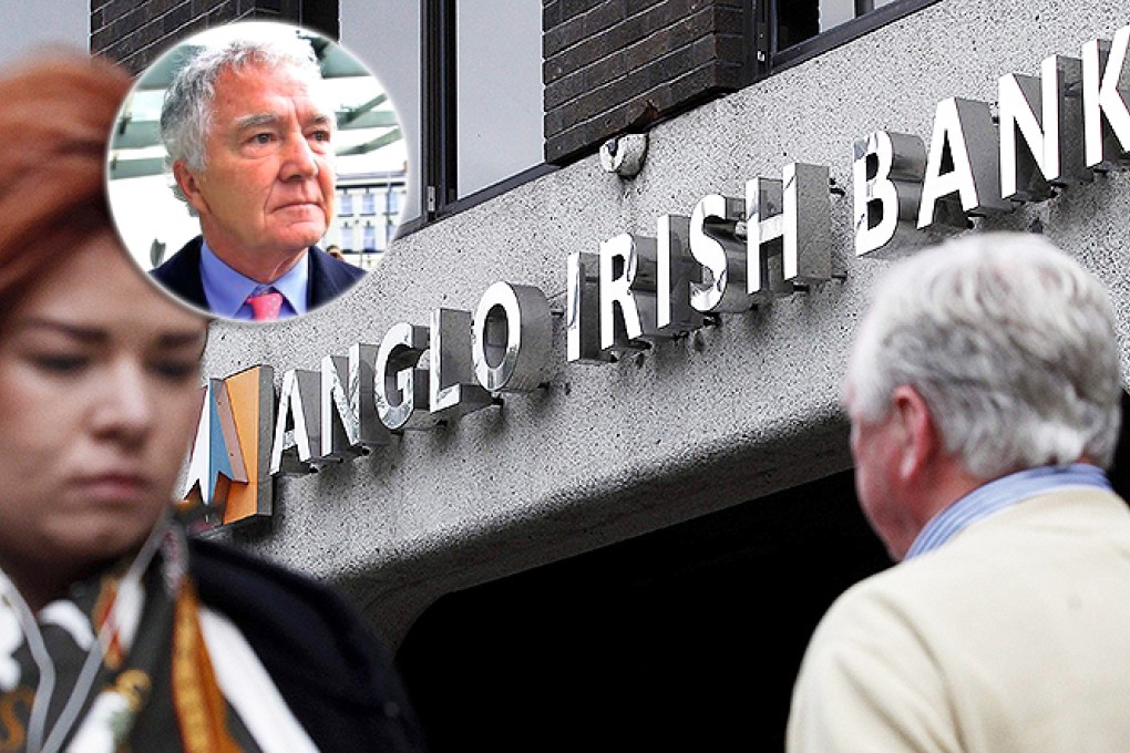 Pedestrians walk past a branch of Anglo Irish Bank in Dublin. Sean FitzPatrick (inset) will each face 16 charges. Photo: Reuters