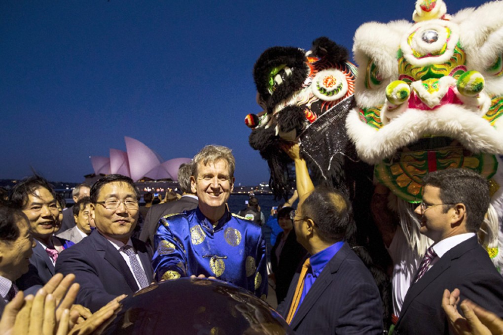 Li Huaxin, centre left, Chinese Consul General to Australia, and NSW Premier Barry O Farrell, centre right, activate lasers that turn the Sydney Opera House's sails red for the Chinese Lunar New Year celebrations in Sydney. Photo: EPA