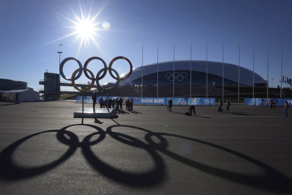 People pose in front of the Olympic rings near the Bolshoy arena in the seaside cluster prior to the start of the 2014 Sochi Winter Olympics. Photo: AFP