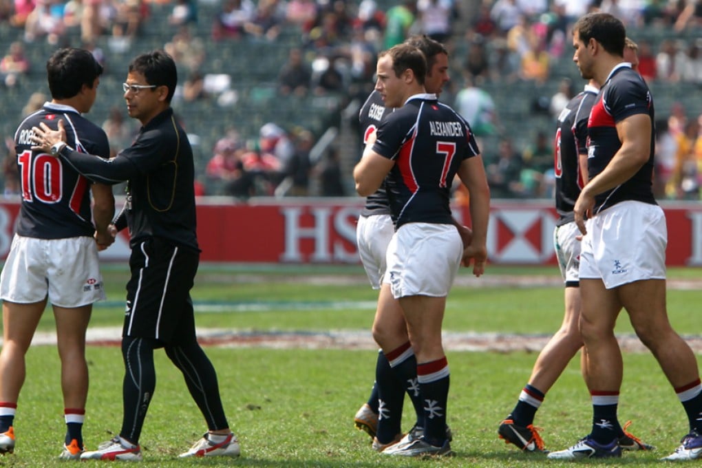 No 10 Keith Robertson joins his Hong Kong teammates to congratulate Japan for their extra-time quarter-final win in the 2012 Hong Kong Sevens qualifier competition. Photo: Felix Wong/SCMP