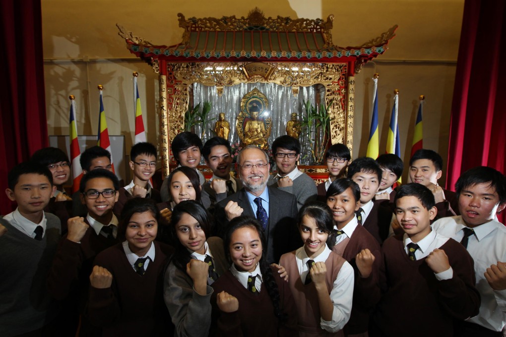 Eric Yuon surrounded by pupils at his Fat Ho school. Photo: Nora Tam
