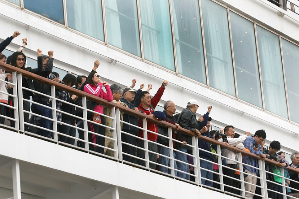 Passengers remain on board the Costa Victoria to demand higher compensation for missing a stop in Ha Long Bay. Photo: Edward Wong