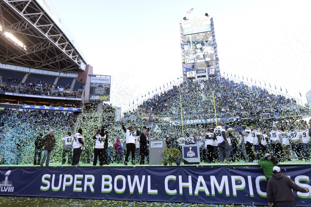 Seattle Seahawks players and coaches celebrate as confetti falls at CenturyLink Field in Seattle. Photo: AP