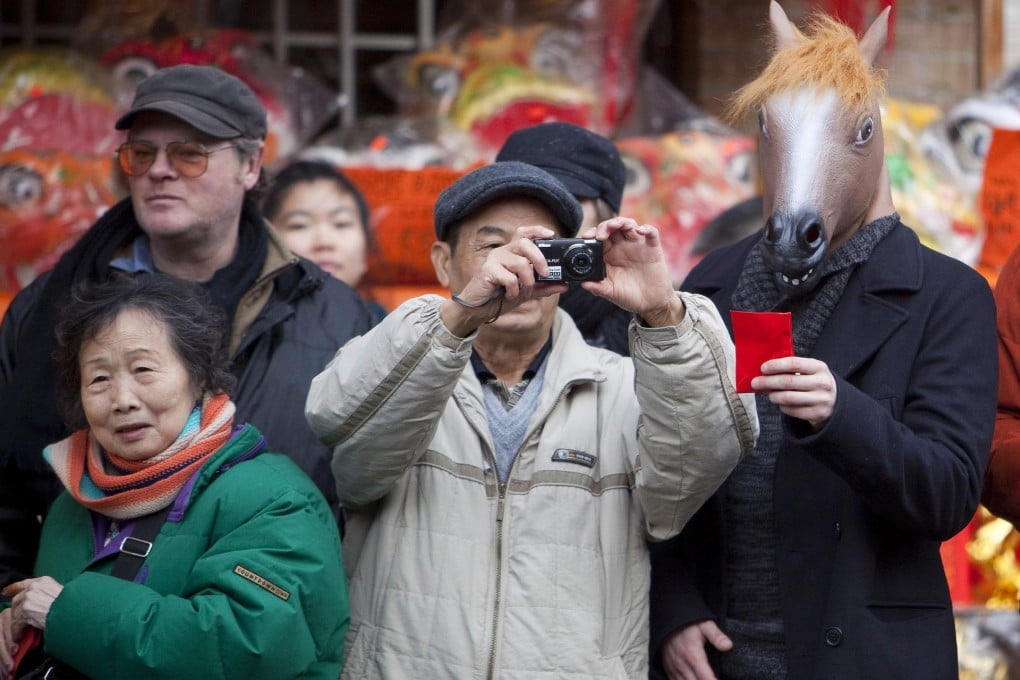 Most applicants for rich investor visas are Chinese wanting to live, like these Lunar New Year revellers, in British Columbia. Photos: Reuters