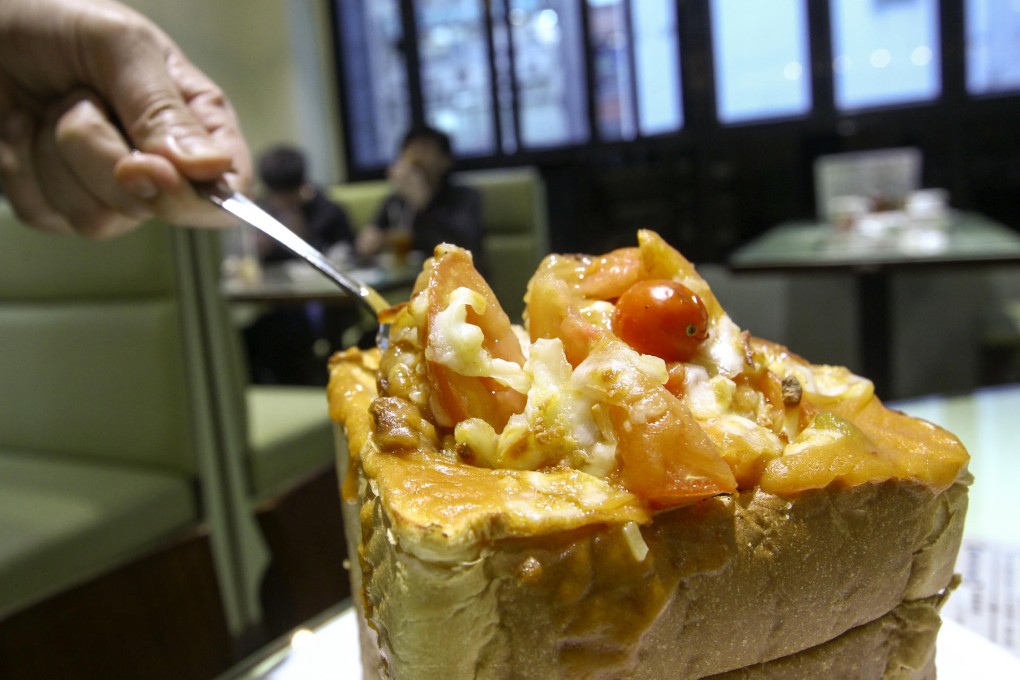 The bing sutt's new golden brick dish features baked tomatoes, rice and pork inside a loaf of white bread. Photos: Jonathan Wong