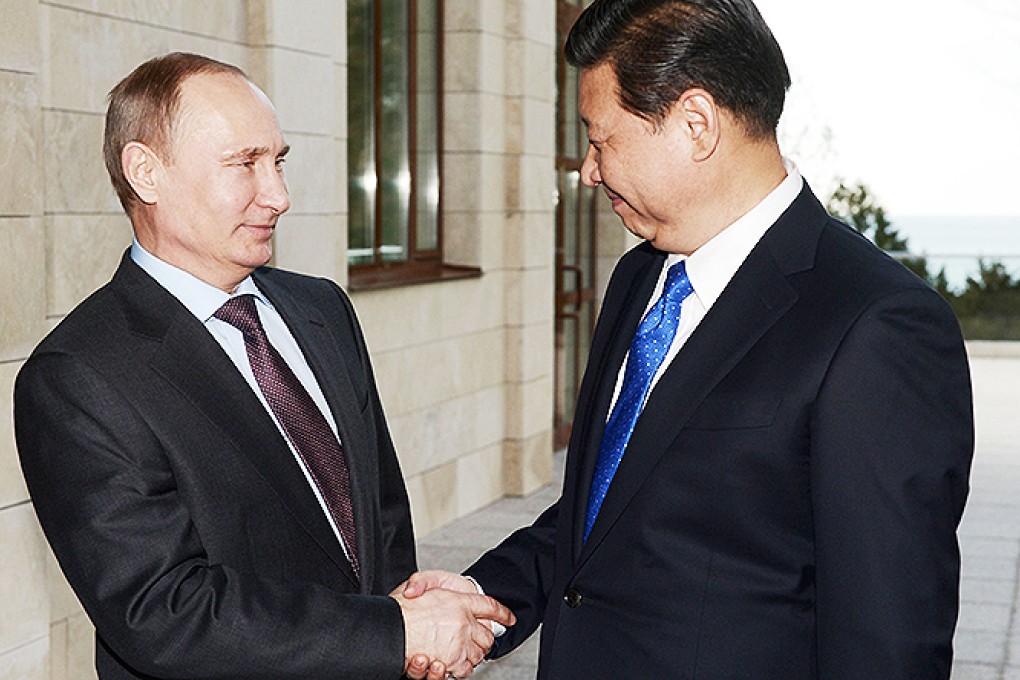 Russian President Vladimir Putin (welcomes Chinese counterpart Xi Jinping during their meeting in the Russian Black Sea resort of Sochi. Photo: AFP