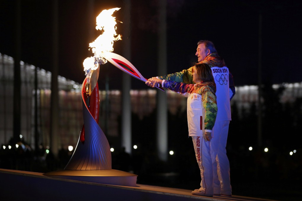 Former hockey player Vladislav Tretiak and figure skater Irina Rodnina light the Olympic cauldron. Photo: Reuters REUTERS