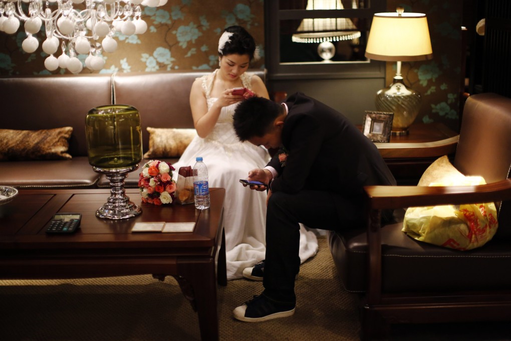 A couple waits to participate in a staged mass wedding, organised as part of a matchmaking event to inspire singles to get married, in Shanghai. Photo: Reuters
