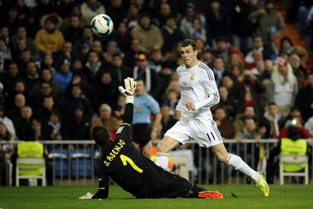 Real Madrid's Welsh forward Gareth Bale scores past Villarreal keeper Sergio Asenjo at the Santiago Bernabeu stadium. Photo: AFP