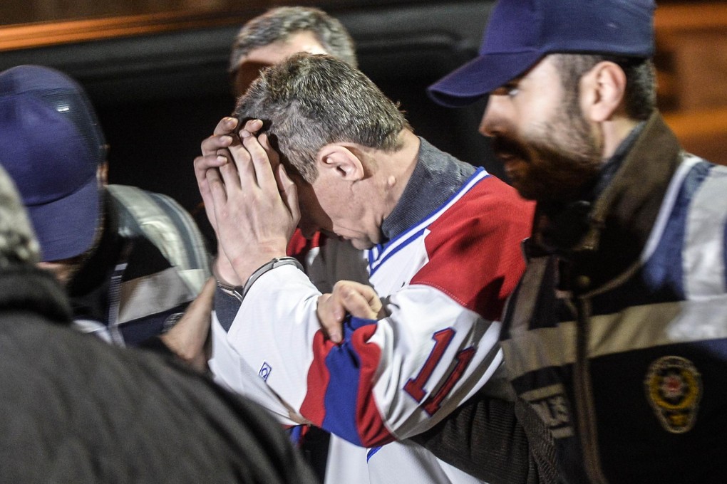 The hijacker is bundled away by Turkish police after the Pegasus Airlines plane landed at its intended destination of Istanbul. Photo: AFP