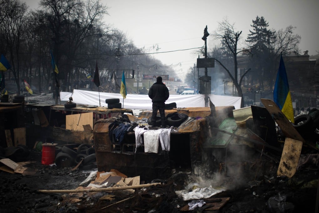 An opposition demonstrator stands on a barricade in Kiev. Photo: AFP