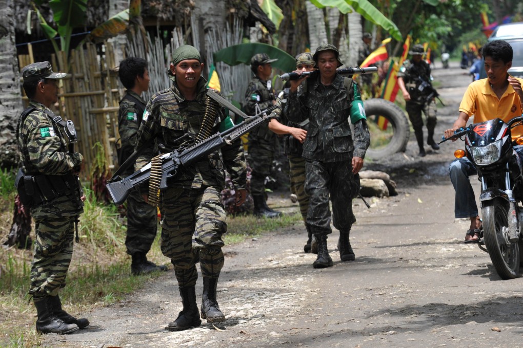 File photo of Moro Islamic Liberation Front (MILF) rebels patrolling inside camp Darapanan in Sultan Kudarat province. Photo: AFP