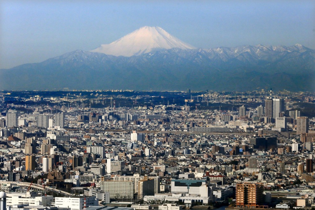Japan's highest peak, Mount Fuji, looms over the capital Tokyo. Photo: EPA