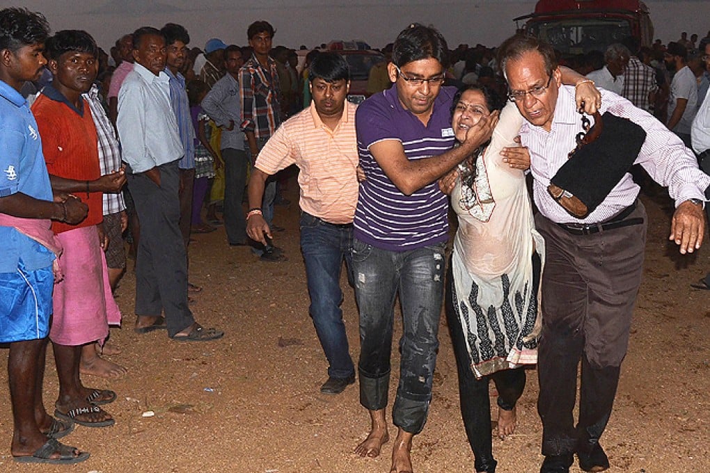 A survivor is assisted at Hirakud reservoir in Sambalpur district, some 320 kilometres from Bhubaneswar on Sunday. Photo: AFP
