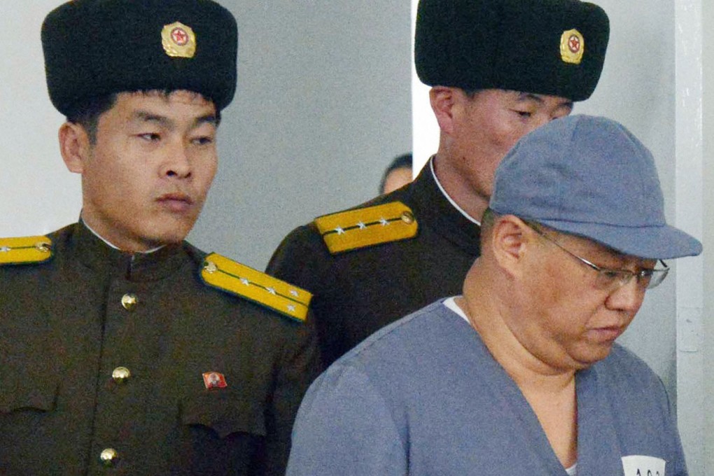 Jailed US missionary Kenneth Bae (right) is escorted by guards to a tightly controlled news conference last month. Photo: Reuters