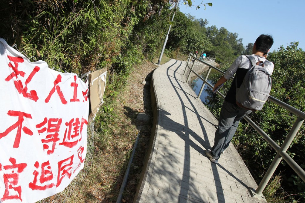 A banner put up by Sai Wan villagers attacking the government plan to include the enclave into surrounding country park.