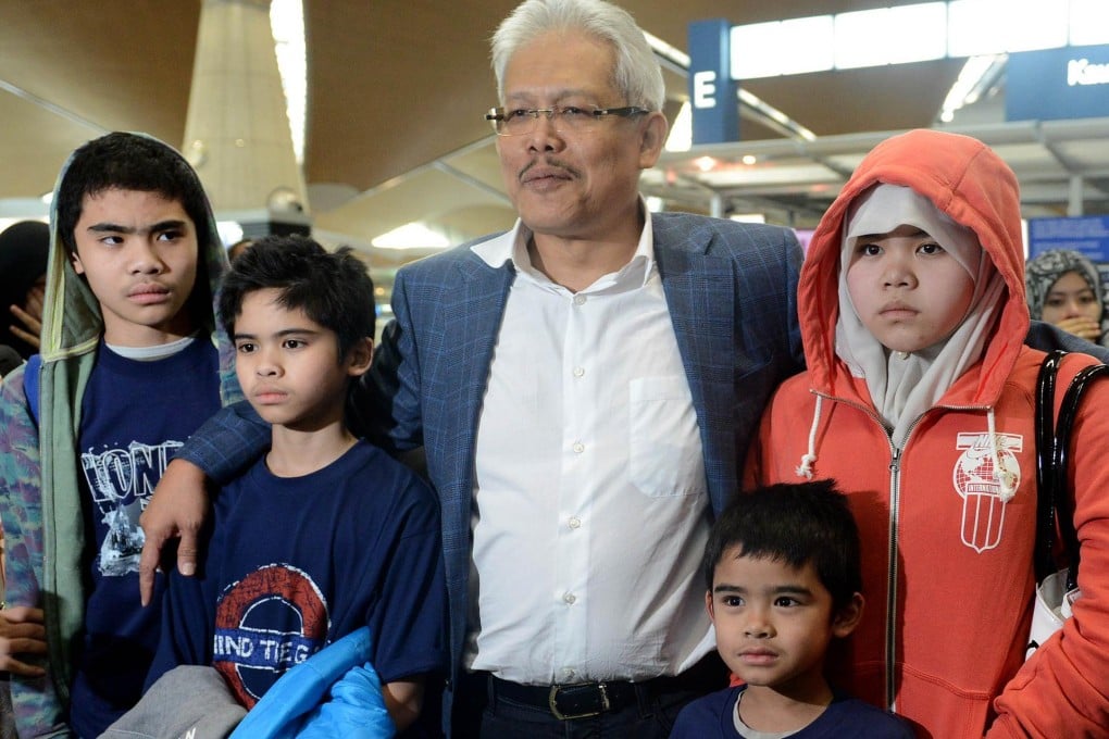 The children, aged between seven and 14, are welcomed back to Malaysia. Photo: AFP