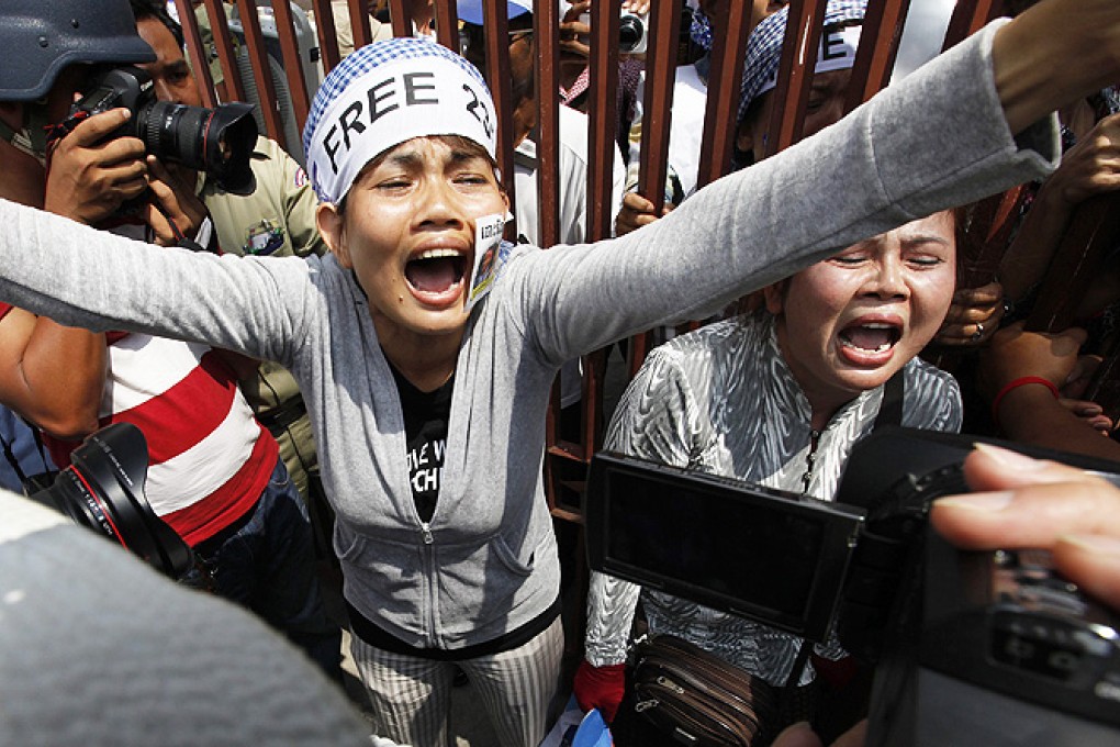 Cambodian protesters react during a protest outside the appeals court in Phnom Penh, Cambodia, on Tuesday. Photo: EPA