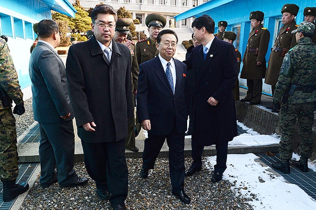 Head of the North Korean delegation Won Tong Yon crosses the border separating the two Koreas at the truce village of Panmunjom. Photo: AFP