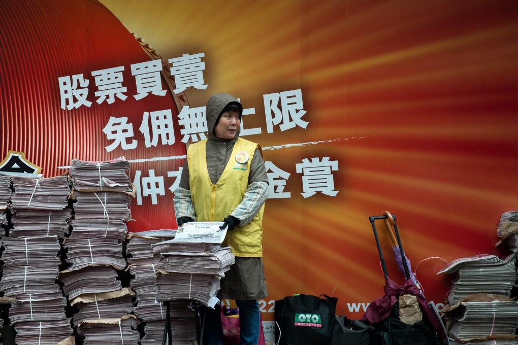 A woman distributes newspapers in Hong Kong. Some reports this week have highlighted an increasingly restricted media landscape. Photo: AFP