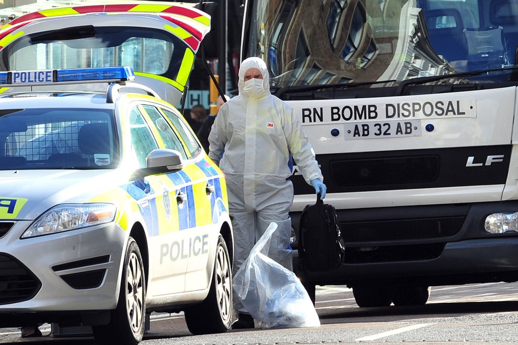 A bomb disposal unit works at the scene where a suspect package was delivered at an Army recruitment office in Brighton, southern England. Photo: AFP