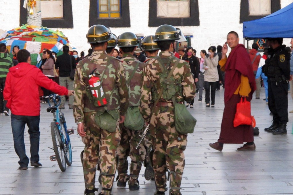 Police patrols with fire extinguisher in Lhasa, Tibet. Photo: EPA