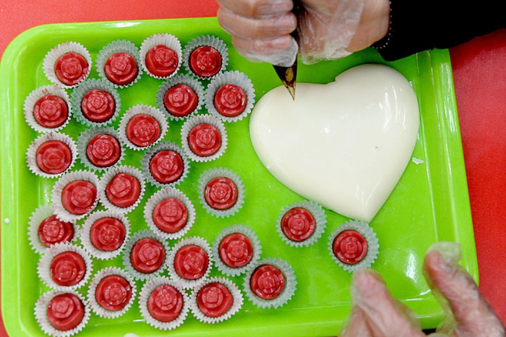 A vendor makes chocolates for Valentine's Day in Shenyang, Liaoning province. Photo: Xinhua