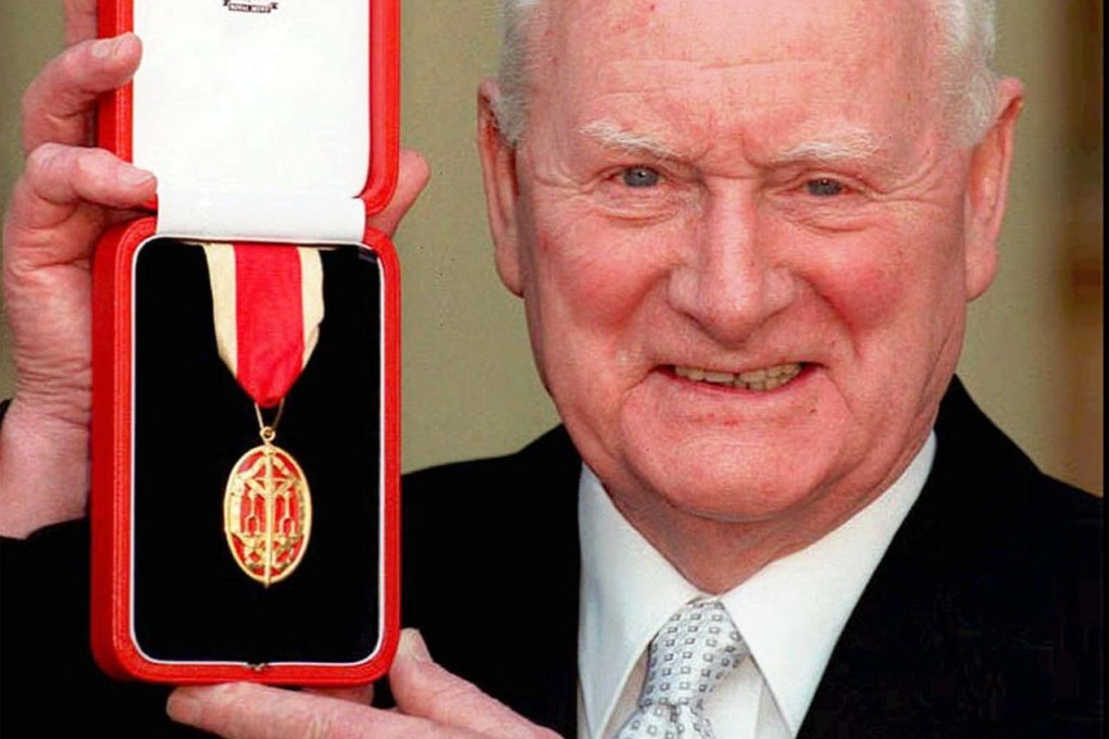 Tom Finney receives his knighthood in 1998. Photo: AP