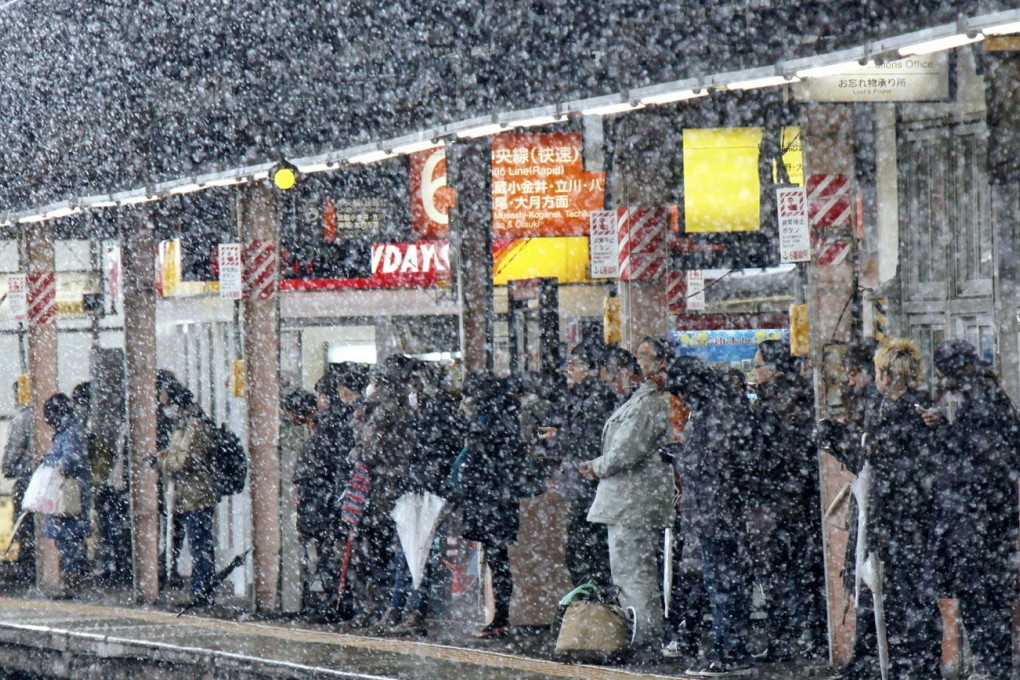 Waiting for the next train in Tokyo, where public transport has been severely disrupted. Photo: Yomiuri Shimbun