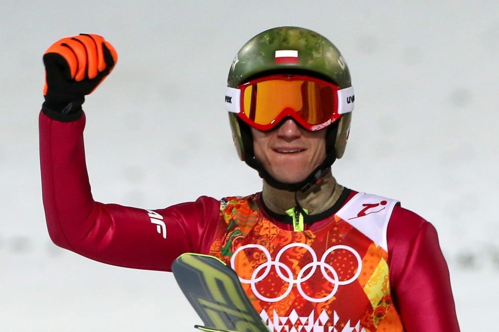 Kamil Stoch punches the air after winning gold. Photo: EPA