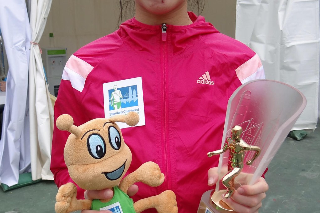 Rebecki Chan Yee-ki shows off her prizes after winning the women's junior 10km race. Photo: Kevin Kung