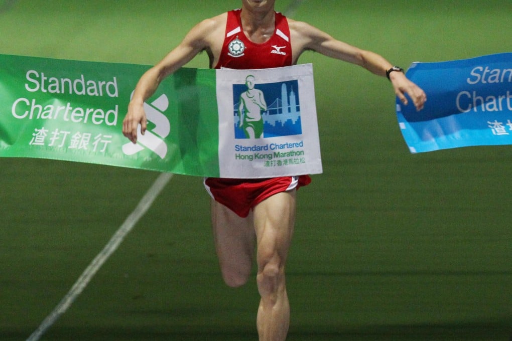 The mainland's Wang Kun beams as he crosses the finish line in Victoria Park in the men's half marathon. Photo: Nora Tam