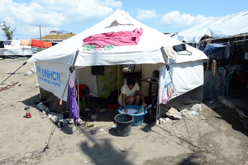 A survivor of Typhoon Haiyan at a tent city along the coastal area of Tacloban City, Leyte province, in central Philippines. Photo: AFP