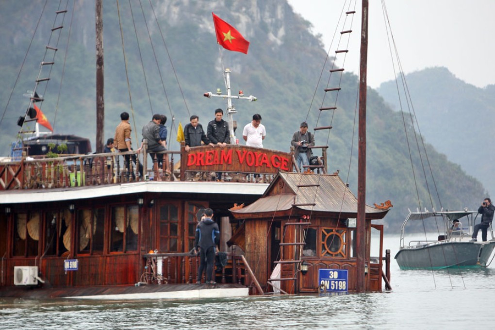 The sunken boat Dream Voyage is being salvaged in Ha Long Bay. Photo: EPA