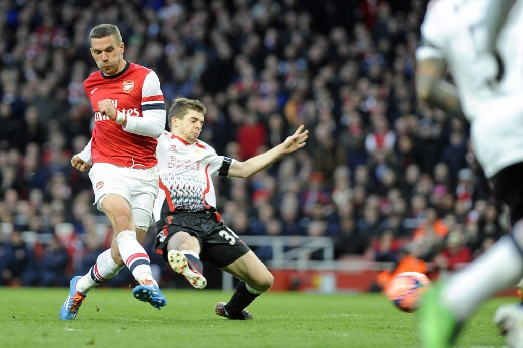 Lukas Podolski puts Arsenal 2-0 up against Liverpool in the FA Cup. Photo: EPA