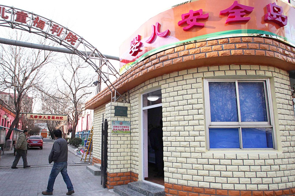 People walk past a baby hatch named 'baby safety island' at the Tianjin Institute of Children's Welfare, in Tianjin municipality. Photo: Reuters
