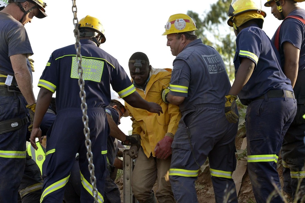 Rescuers tend to one of the 11 workers who was rescued from the illegal mine at Benoni, just outside Johannesburg. Photo: AFP