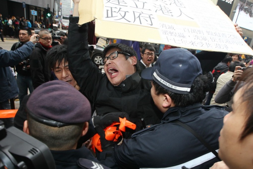A protester holds up a placard during Sunday's march, where demonstrators chanted 'go back to China'. Photo: Felix Wong