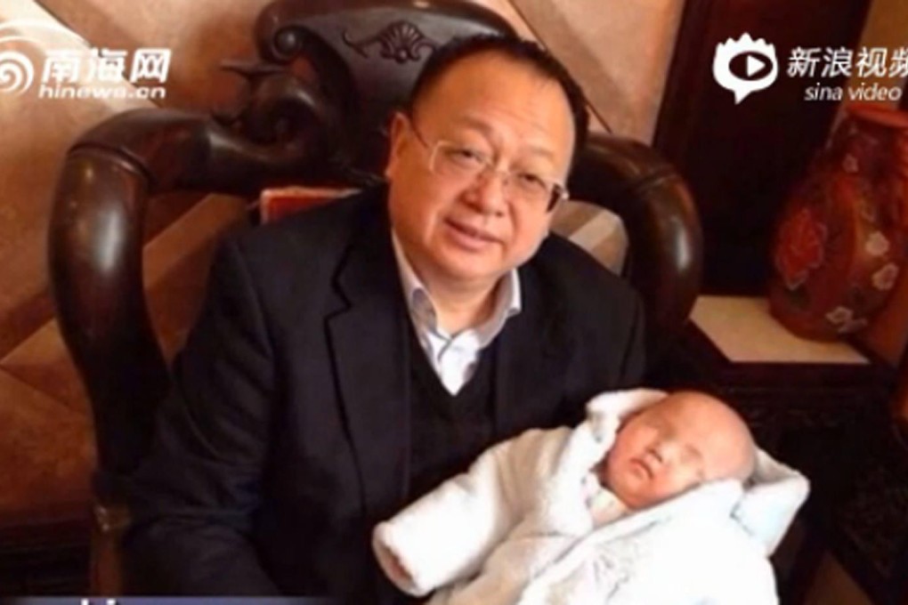 A photo posted online by Li Shanshan of Henan provincial People's Congress deputy Luo Zhiyuan holding their daughter. Photo: SCMP Pictures