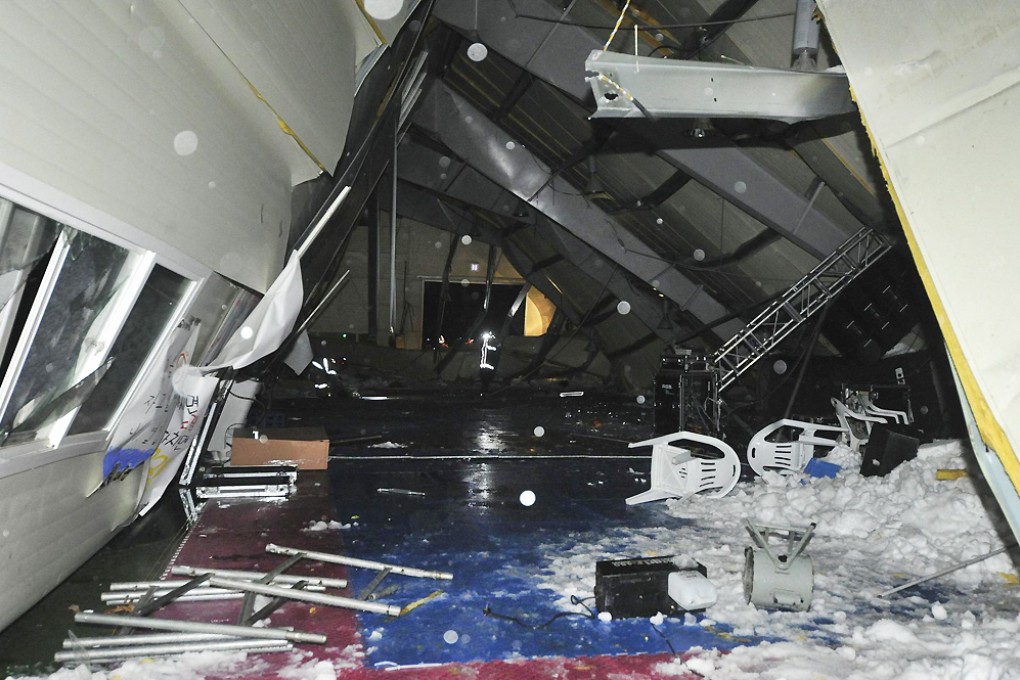 The collapsed roof at the resort in Gyeongju, south of Seoul, and some of the snow that fell inside. Photo: Reuters
