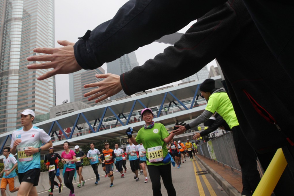 Participants run in Central during Standard Chartered Hong Kong Marathon 2014. Photo: Felix Wong