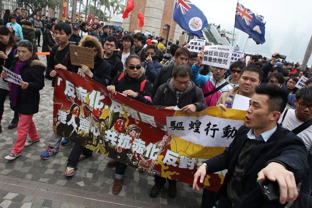 Members of group of netizens march from the Star Ferry in Tsim Sha Tsui to Canton Road.