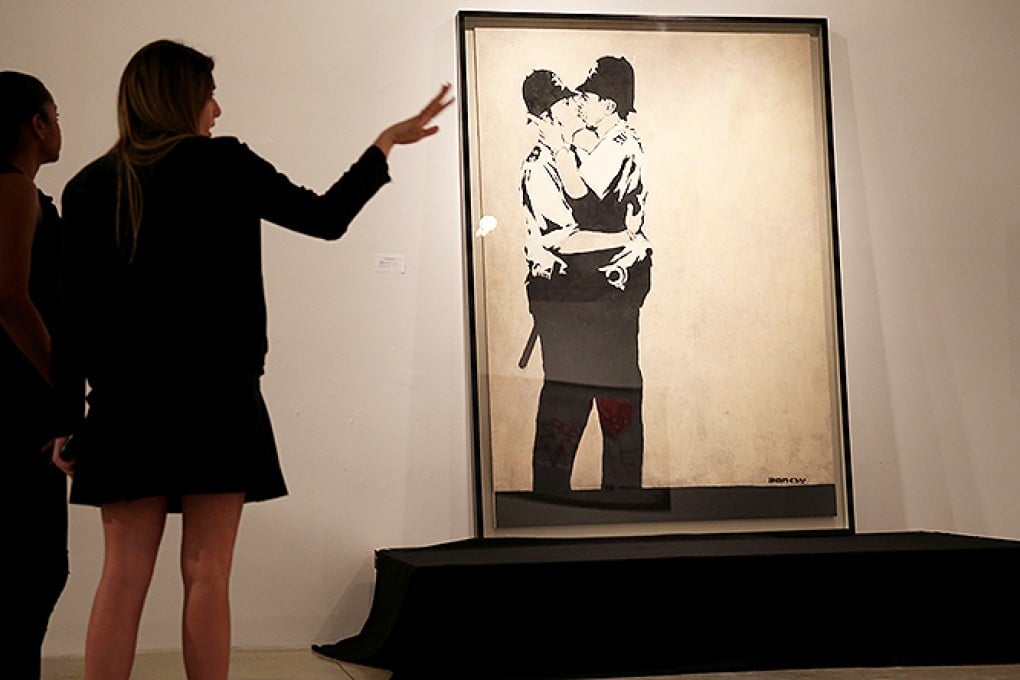 Kissing Coppers is displayed ahead of auction at a Miami gallery. Photo: AFP